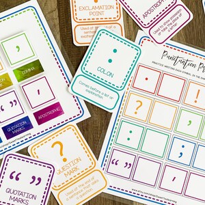 May include: A colourful set of punctuation practice cards featuring various punctuation marks, such as a comma, full stop, question mark, exclamation mark, colon, semi-colon, quotation marks, and apostrophe. The cards are printed on white cardstock with colourful borders and text. The cards are arranged in a grid pattern on a wooden surface.