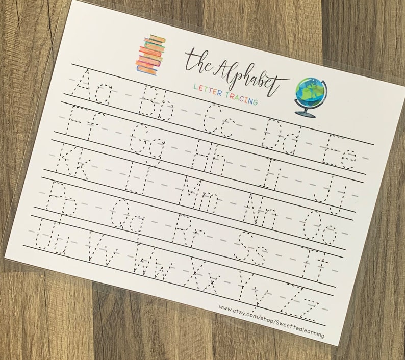 May include: A white letter tracing worksheet with the alphabet in dotted lines for tracing. The title "the Alphabet" is written in cursive, with a stack of books and a globe illustration. The website address is at the bottom.