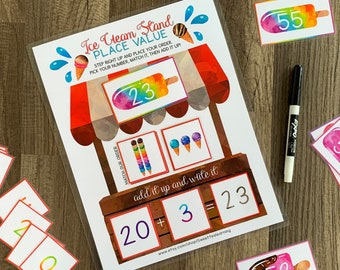 May include: A printable ice cream stand game for kids to practice place value and addition. The game includes colorful ice cream cones, popsicles, and number cards. The text on the game says "Ice Cream Stand Place Value" and "Step right up and place your order. Pick your number, match it, then add it up!"
