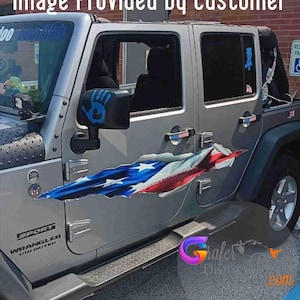 May include: Silver Jeep Wrangler Unlimited with a patriotic American flag design on the side. The flag graphic appears to be tearing through the vehicle's body. The vehicle has a black side step and a "SPORT" emblem.