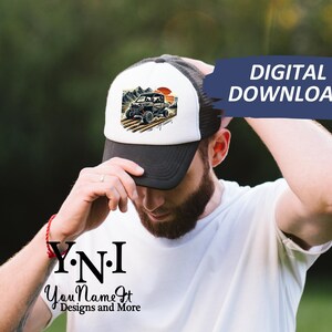 May include: A white and black trucker hat with a graphic of a black off-road vehicle driving through a desert landscape. The hat has a black mesh back and a white front with the text "Y.N.I. You Name It Designs and More".