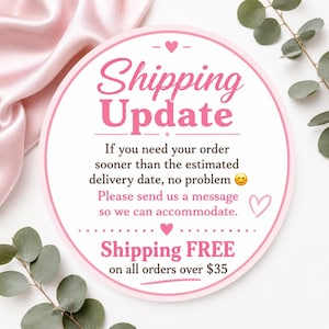 May include: A circular white sign with a pink border featuring the text Shipping Update, followed by instructions to message for faster delivery, and a note about free shipping on orders over $35, decorated with small pink hearts and a smiley face.