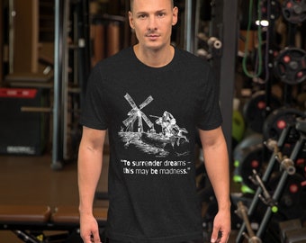 May include: Black t-shirt featuring a white graphic of a windmill and a person riding a horse. The text "To surrender dreams - this may be madness." is printed below the graphic.