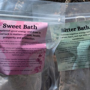 May include: Two sealed bags of herbal bath tea. One bag has a pink label with the text "Sweet Bath" and instructions. The other bag has a green label with "Bitter Bath" and instructions. Both bags are in clear plastic.