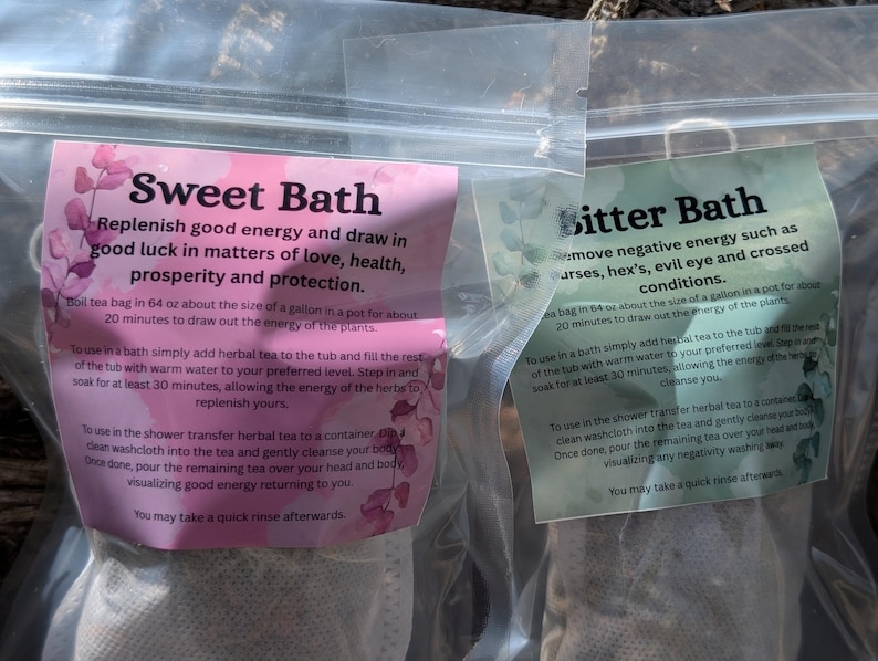 May include: Two sealed bags of herbal bath tea. One bag has a pink label with the text "Sweet Bath" and instructions. The other bag has a green label with "Bitter Bath" and instructions. Both bags are in clear plastic.