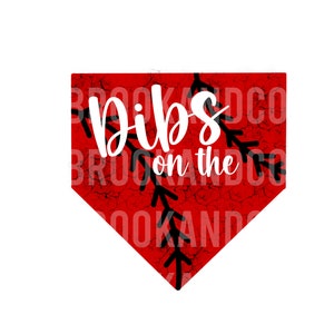 May include: Red baseball-shaped sign with a white distressed background and black stitching. The sign says "Dibs on the" in white cursive text.