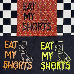 May include: Three fabric patches with the phrase "EAT MY SHORTS" and a cartoon character illustration. One patch is red with a repeating pattern, and the other two are black with orange and yellow text and illustrations.