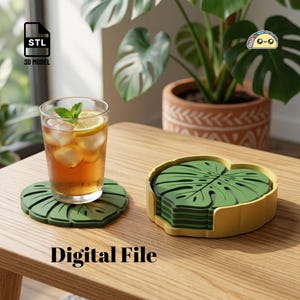 May include: A set of green monstera leaf-shaped coasters with a yellow holder. One coaster sits under a glass of iced tea with a lemon slice and mint garnish. The text STL 3D MODEL and Digital File are visible in the image.