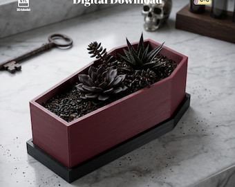 May include: A maroon coffin-shaped planter with a black base, containing dark green succulents in soil. The image includes the text Digital Download and 3D Model. A metal key and a skull are visible in the background, along with small glass bottles.