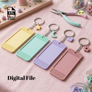 May include: Four rectangular keychains in pastel yellow, mint green, lavender, and dusty rose, each featuring a metal ring and a small charm shaped like a star, moon, heart, or flower. The keychains have ribbed ends and are labeled as a 3D model digital file.