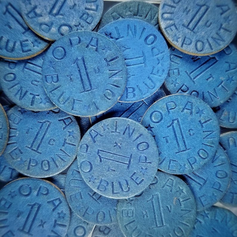 May include: A close-up of a pile of blue poker chips with the words "1 Blue Point" printed on them.