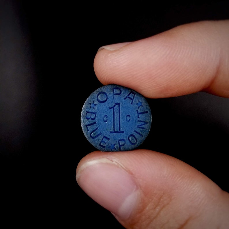 May include: A blue poker chip with a white star design and the text "One Blue Point" in a circle.