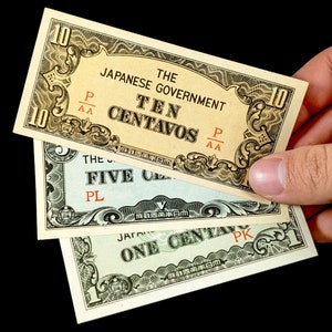 May include: Three vintage Japanese government banknotes, one for ten centavos, one for five centavos, and one for one centavo. The banknotes are in various shades of green, blue, and yellow with black and red text.
