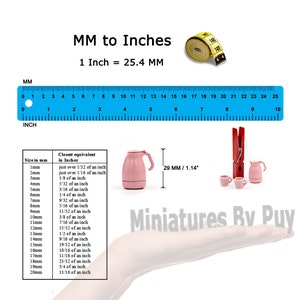 May include: A pink miniature teapot and two cups with a red clothespin next to them. A ruler with markings in millimeters and inches is shown with a conversion chart for millimeters to inches. The text "29 MM / 1.14" is shown next to the teapot. The text "Miniatures By Puy" is shown below the teapot.