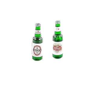 May include: Two green glass beer bottles. One bottle has a white label with the text "BECK'S" and a circular emblem. The other bottle has a white label with the text "STELLA ARTOIS LEGERE". Both bottles have silver bottle caps.