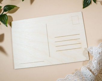 May include: A blank wooden postcard with a space for a stamp and lines for writing a message.