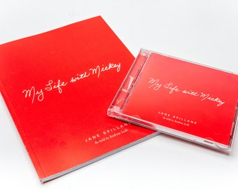 May include: A red book and CD set titled "My Life with Mickey" by Jane Spillane. The book is titled "As told to Andrew Lesh".
