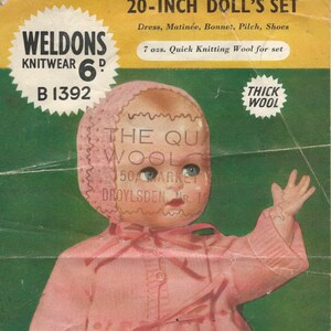 May include: Vintage doll's set pattern featuring a doll in a pink knitted outfit, including a bonnet, dress, and shoes. The image includes text that reads "Weldons Knitwear" and "20-inch Doll's Set". The pattern requires 7 ozs. of thick wool.