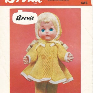 May include: A vintage doll dressed in a yellow knitted coat, leggings, and bonnet. The coat features white trim and two buttons. The doll has blonde hair and blue eyes. The image includes the text "Bronte" and "DOLLS COAT, LEGGINGS AND BONNET".