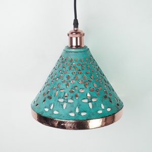 Image of cone copper lights combining hand-carved cut-out pattern with green patina finish and small strip of hand-hammered pattern with polished copper finish, with natural copper finish interior.