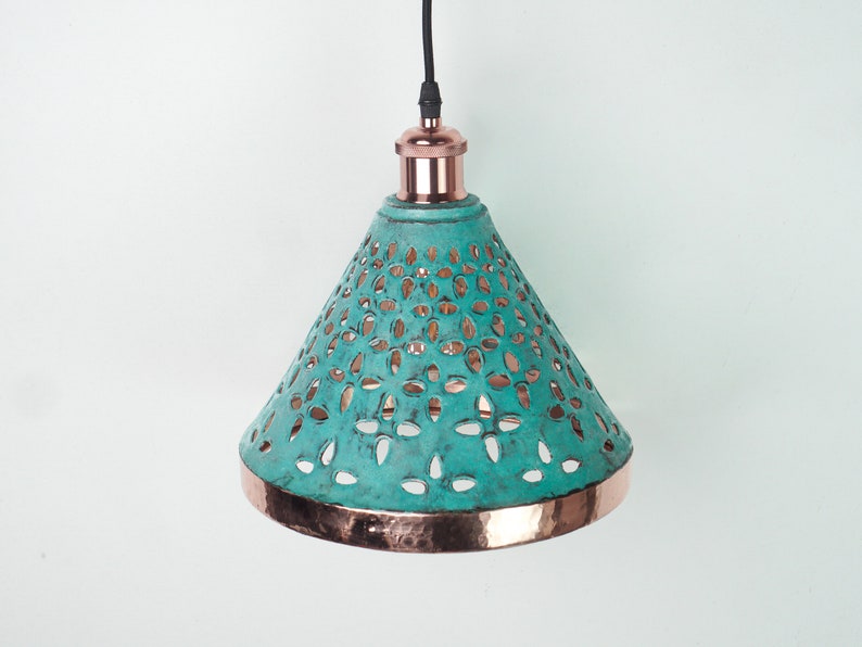 Image of cone copper lights combining hand-carved cut-out pattern with green patina finish and small strip of hand-hammered pattern with polished copper finish, with natural copper finish interior.