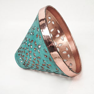 Side view image of cone copper lights combining hand-carved cut-out pattern with green patina finish and small strip of hand-hammered pattern with polished copper finish, with natural copper finish interior.