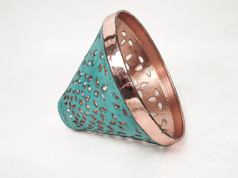 Side view image of cone copper lights combining hand-carved cut-out pattern with green patina finish and small strip of hand-hammered pattern with polished copper finish, with natural copper finish interior.