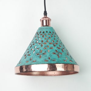 Image of cone copper lights combining hand-carved cut-out pattern with green patina finish and small strip of hand-hammered pattern with polished copper finish, with natural copper finish interior.
