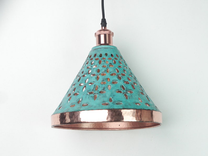 Image of cone copper lights combining hand-carved cut-out pattern with green patina finish and small strip of hand-hammered pattern with polished copper finish, with natural copper finish interior.