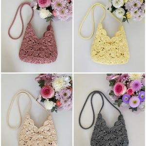 May include: A set of four crochet crossbody bags, each featuring a scalloped edge and a long braided strap. The bags are available in dusty rose, pale yellow, cream, and charcoal gray, all showcasing a detailed fan-like stitch pattern.