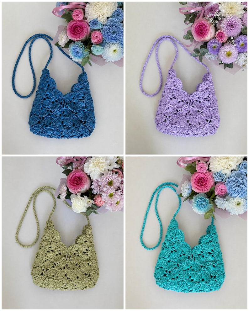 May include: A collection of four crochet bags in blue, lavender, sage green, and turquoise. Each bag features a scalloped shell pattern, a matching braided shoulder strap, and a V-shaped top opening, displayed alongside a bouquet of flowers.