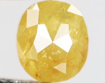 May include: A round, faceted, yellow diamond with a bright, polished finish.