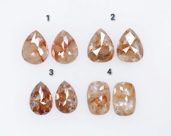 May include: Six loose diamonds in various shapes and sizes. The diamonds are pear-shaped and cushion-shaped. The diamonds are a light brown color with a hint of red.