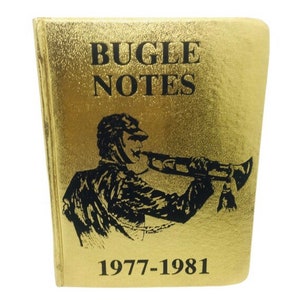 May include: A gold-colored book with the title "BUGLE NOTES" in black lettering. Below the title is a black illustration of a person playing a bugle. The years "1977-1981" are printed at the bottom.