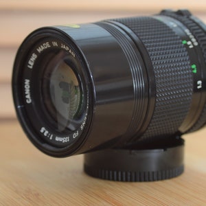 Gorgeous Canon FD 135mm f3.5 lens with built in lens hood. Beautiful lens.