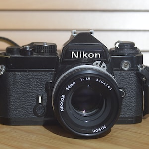 Nikon Black FE With Nikkor 50mm f1.8 Lens Starter Pack. Comes with Lens, Strap and More