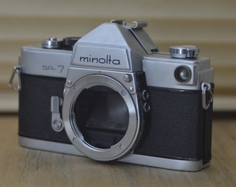 Gorgeous Minolta SR7 60s SLR (Body only). These are very solid and striking vintage cameras. Would be a lovely gift for Loved ones!