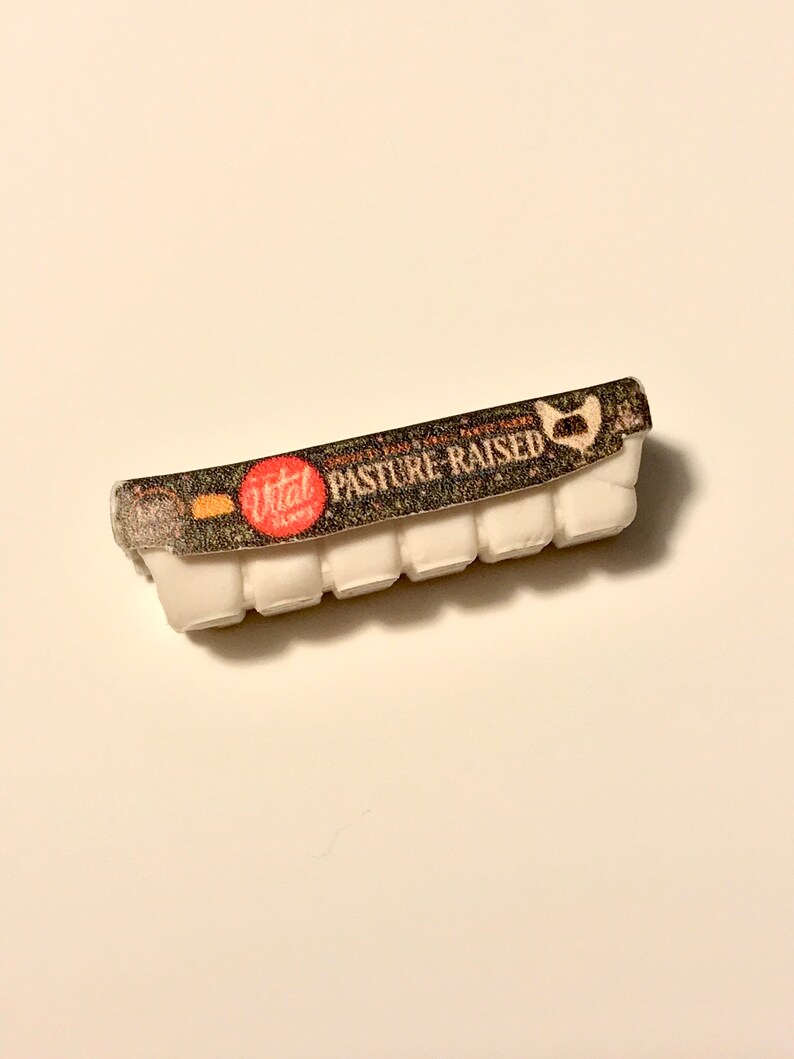 May include: A white egg carton with a black and white label that says "Vital Farms Pasture-Raised" in red letters.