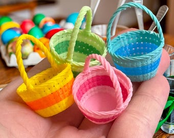 May include: Four small, colorful, woven baskets with handles. The baskets are striped in green, blue, yellow, and pink.