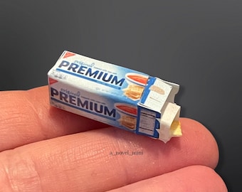 May include: A miniature box of original flavor Premium crackers. The box is blue and white with a red and white image of a cracker and a bowl of tomato soup.