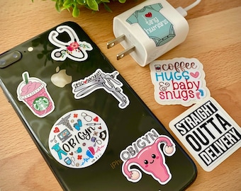 May include: A set of mini OB/GYN stickers featuring various designs, including a stethoscope with flowers, a uterus with a happy face, a coffee cup with the text "coffee hugs & baby snugs", and a phone case with the text "OB/GYN" and "straight outta delivery".