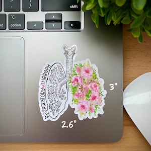 May include: A white sticker with a black line drawing of a lung with pink watercolor flowers. The sticker says "Respiratory Therapy" with a heart symbol. The sticker is 2.6 inches by 3 inches.