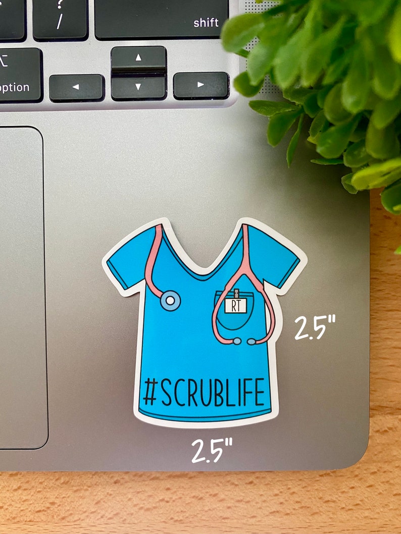 May include: A blue and pink 2.5 inch sticker of a medical scrub top with a stethoscope and name tag that says "RT". The sticker has the text "#SCRUBLIFE" on it.