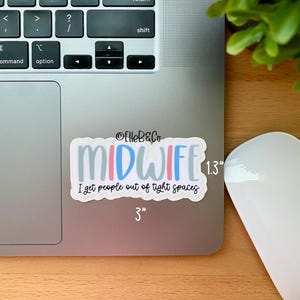 May include: A white sticker with a light blue, pink, and gray design that says "MIDWIFE" with the text "I get people out of tight spaces" below. The sticker is 3 inches wide and 1.3 inches tall.
