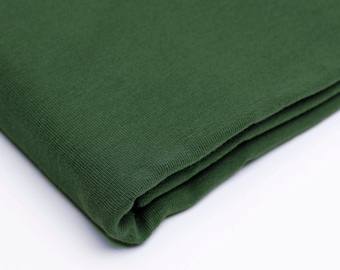 May include: A folded piece of dark green fabric. The fabric has a soft, textured surface.