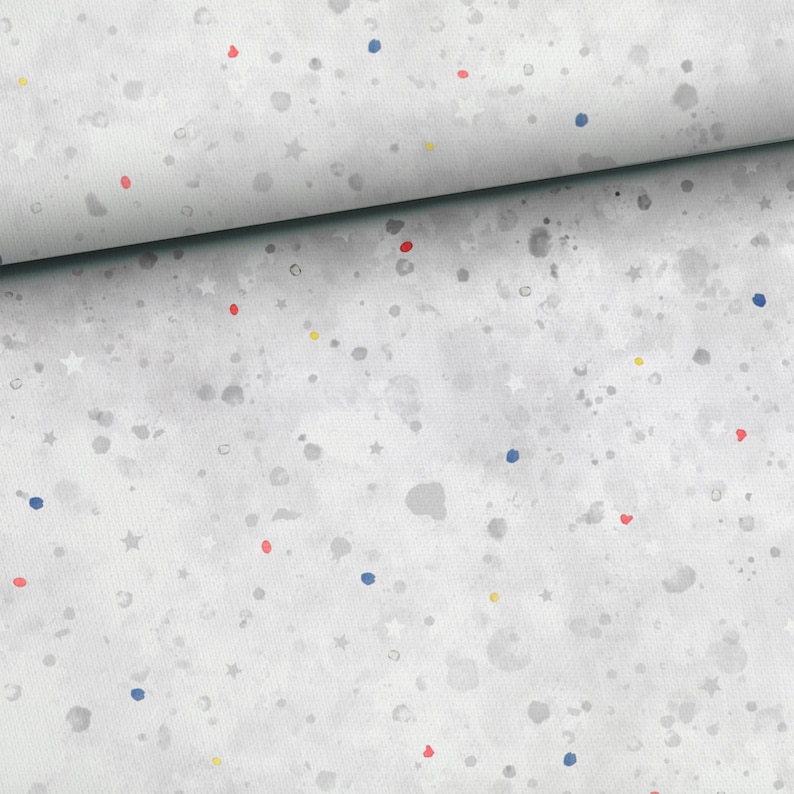 May include: White fabric with a scattered pattern of small blue, red, and yellow dots and white stars.
