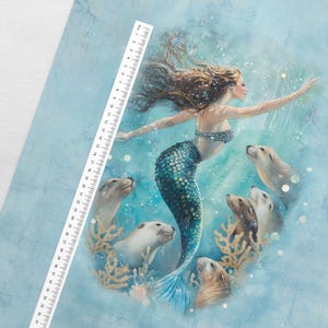 May include: A watercolor illustration of a mermaid with flowing brown hair and a teal tail, surrounded by seals and coral. The mermaid is wearing a blue and silver seashell top. A ruler with centimeter markings is in the upper left corner.