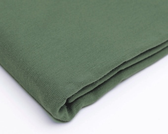 May include: A folded piece of dark green fabric. The fabric has a soft, textured surface.