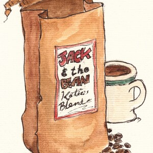 May include: A brown paper bag with the text "Jack & the Bean Katie's Blend" on a red label. A white coffee cup with brown coffee inside is next to the bag. There are brown coffee beans scattered on the white background.