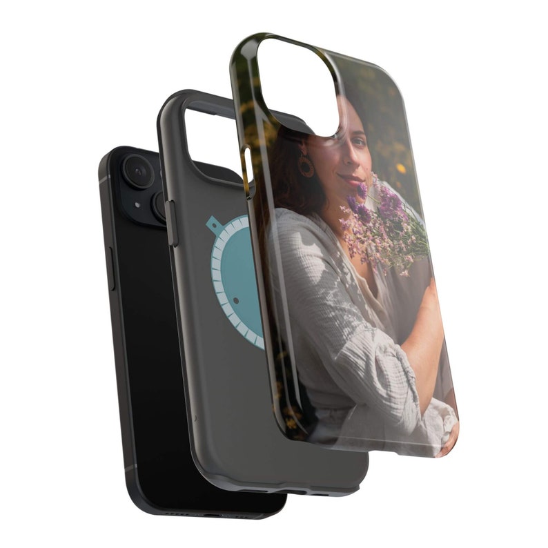 May include: A black phone case with a clear back panel featuring a photo of a person holding flowers. The case has a blue and white design on the side.